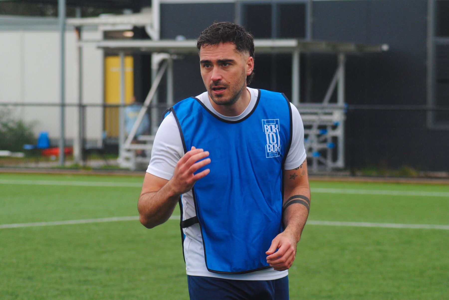 A player wearing a blue Box To Box Football training bib during a real Sydney training session