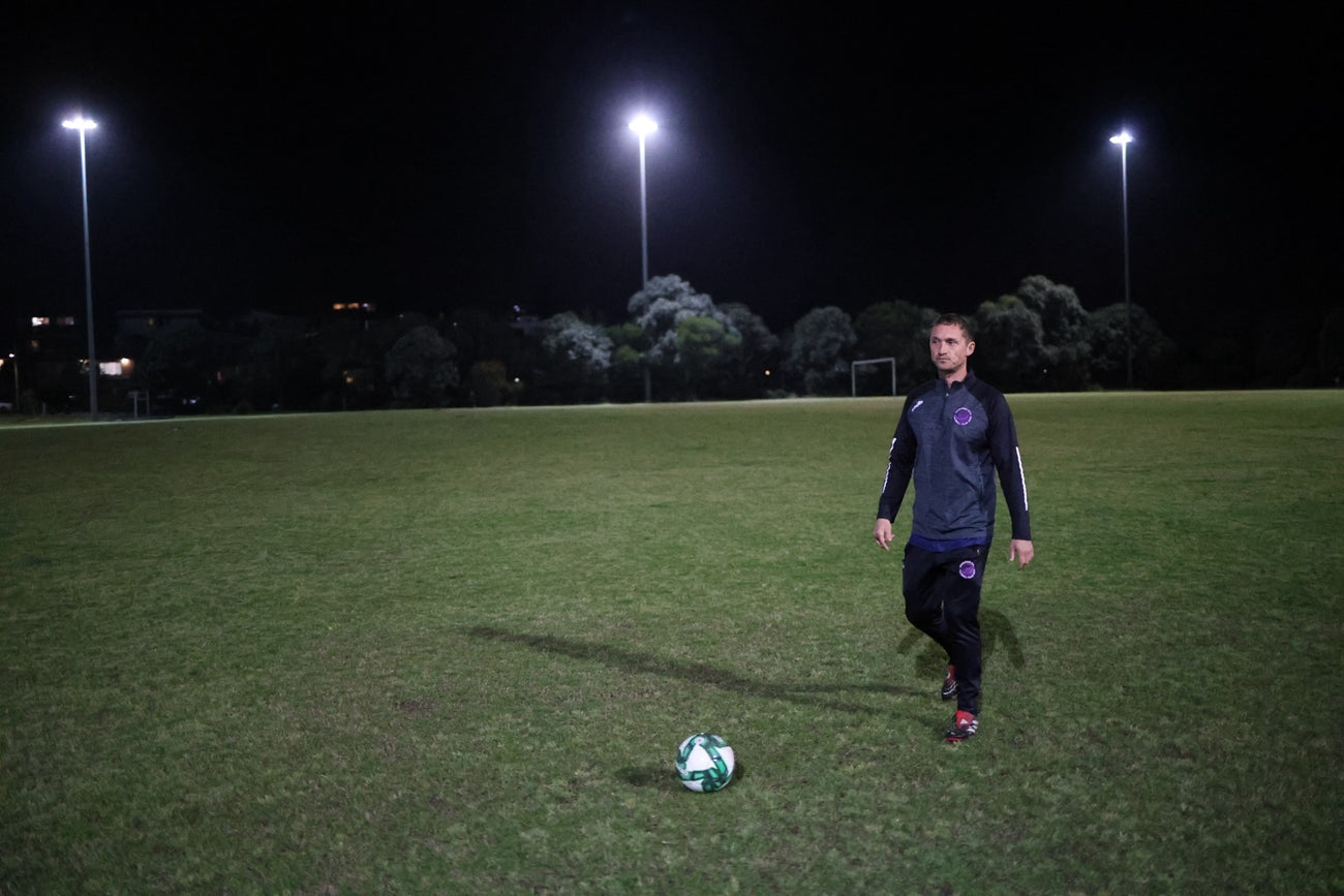Calum Mclellend walking towards a football at Randwick City training