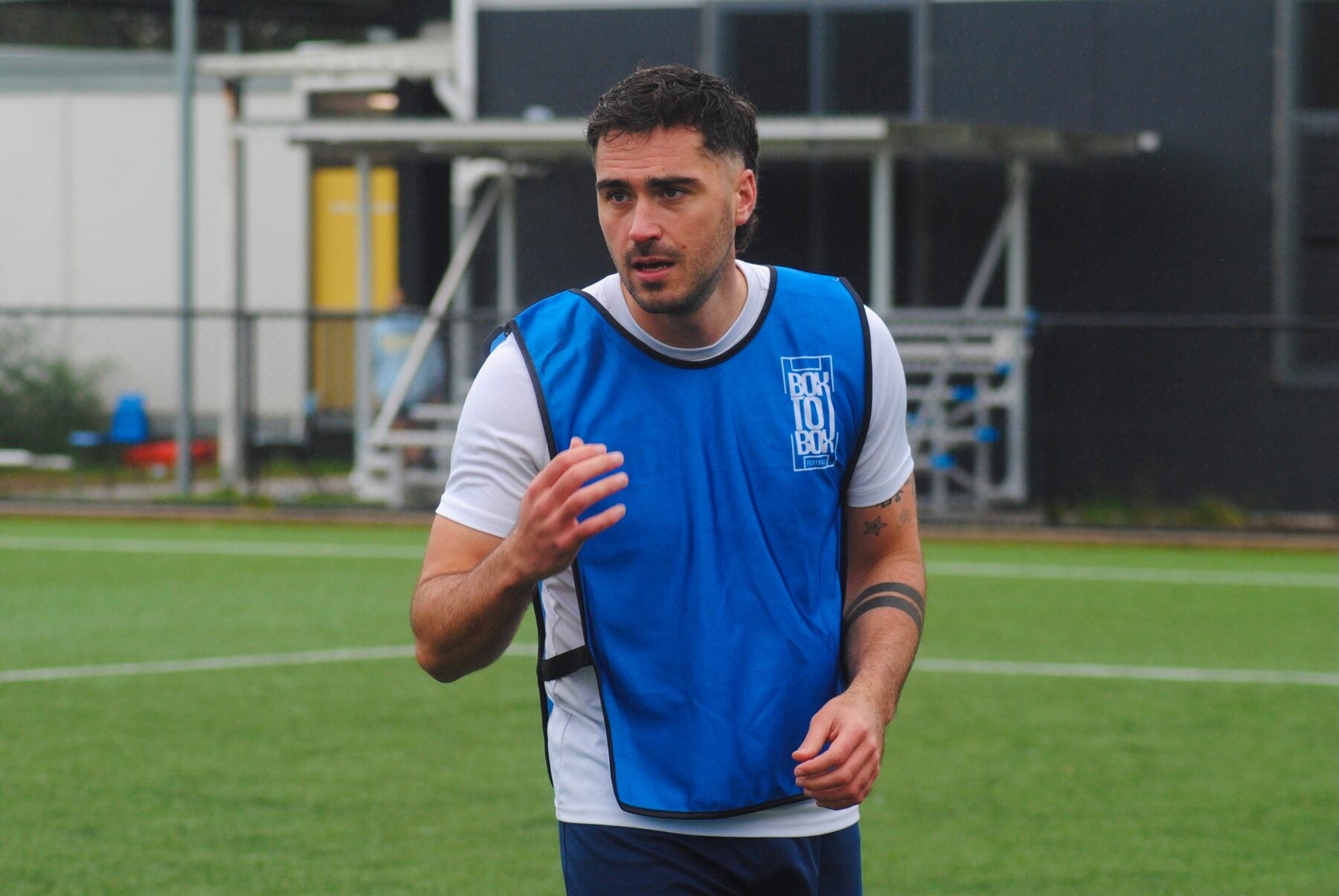 A player wearing a blue Box To Box Football training bib during a real Sydney training session